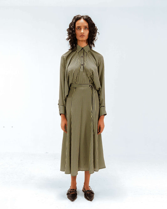 Woman wearing a green and white striped dress on a white background from Leh Studios.