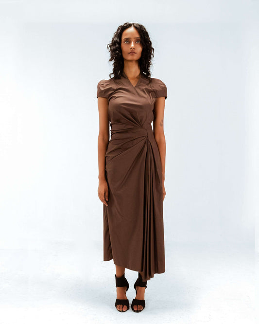 Woman wearing a brown dress on a white background from Leh Studios.