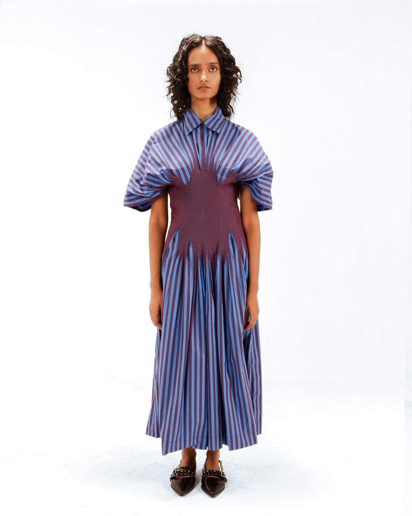 Woman wearing a striped dress with a white background from Leh Studios.