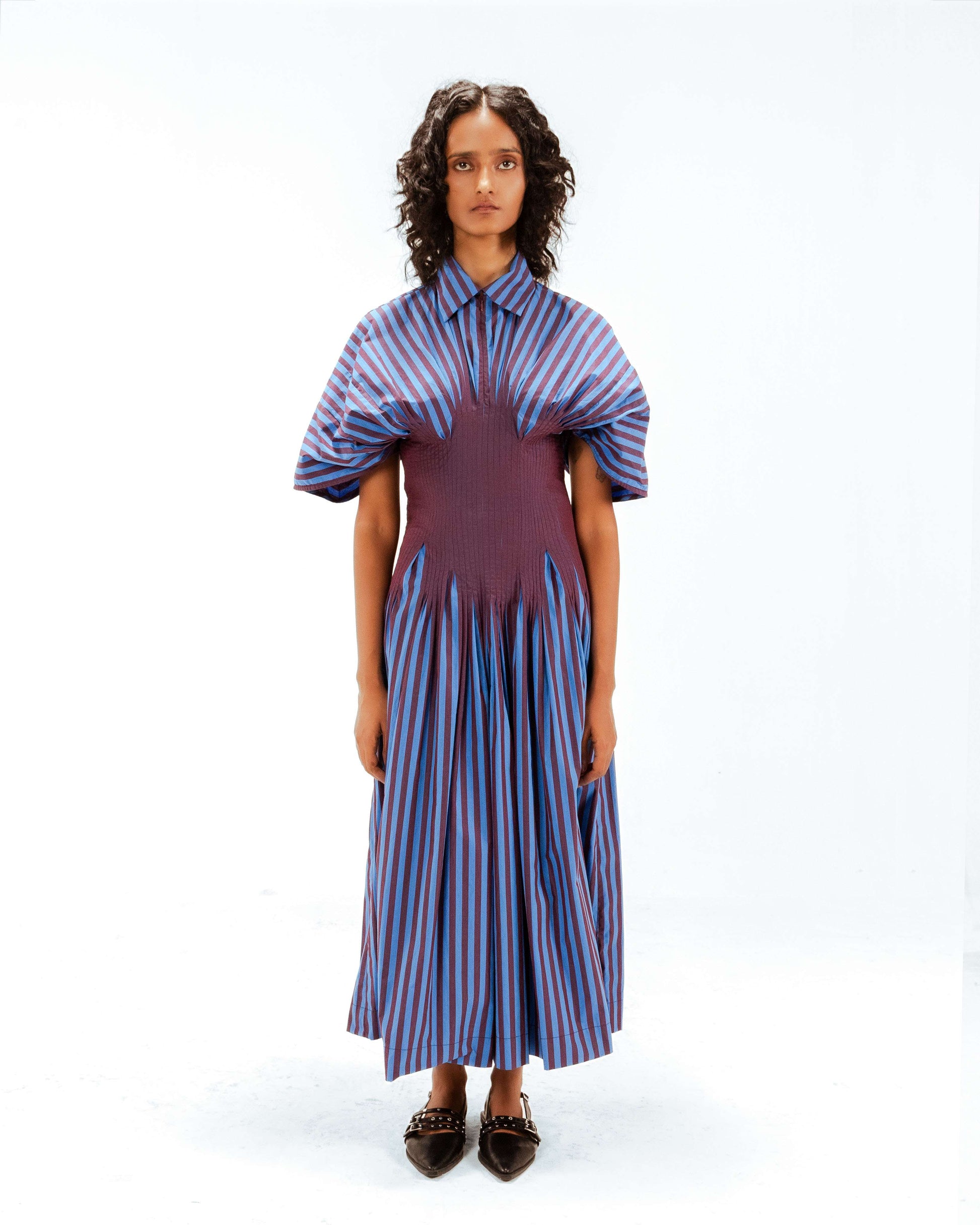 Woman wearing a striped dress with a white background from Leh Studios.