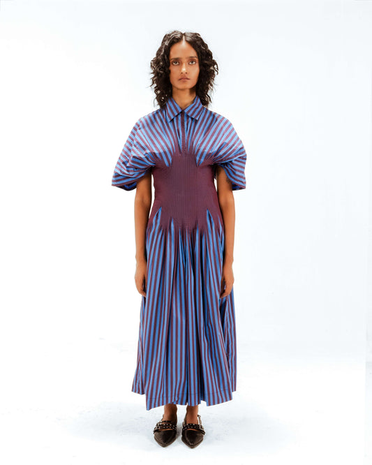 Woman wearing a striped dress with a white background from Leh Studios.