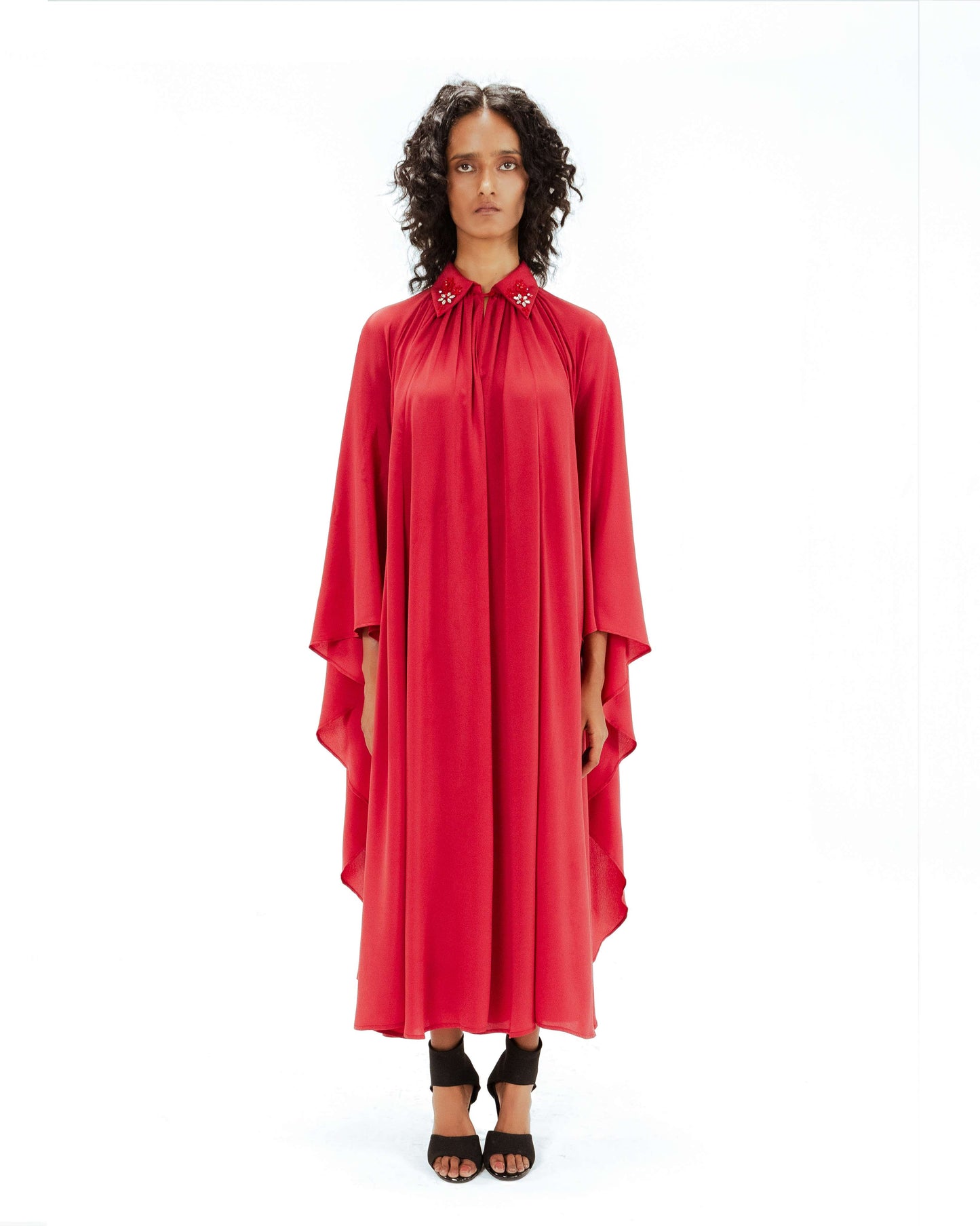 Woman wearing a red dress on a white background from Leh Studios.