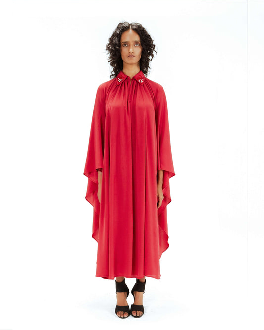 Woman wearing a red dress on a white background from Leh Studios.