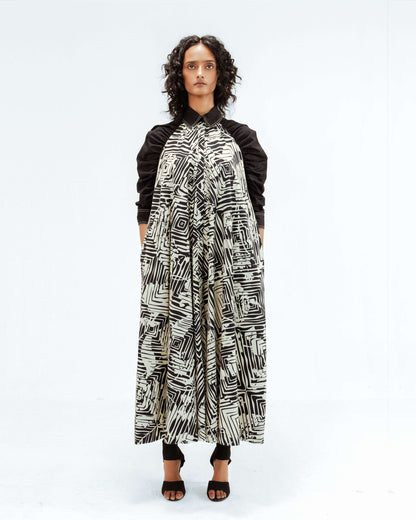 Experience contemporary design with the Leh Studios Florix Print Fable Dress from the Rhythm of time collection. This elegant black and white patterned womens apparel, made with a collared neckline and long sleeves, embraces ethical fashion principles and eco-friendly design.