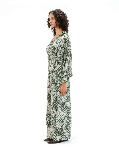 Model wearing the Leh Studios Florix Print Crepe Cape Dress, a beautiful example of artisanal craftsmanship and ethical fashion. This flowy green and cream printed dress from the Rhythm of time collection offers a unique blend of Indian traditions.