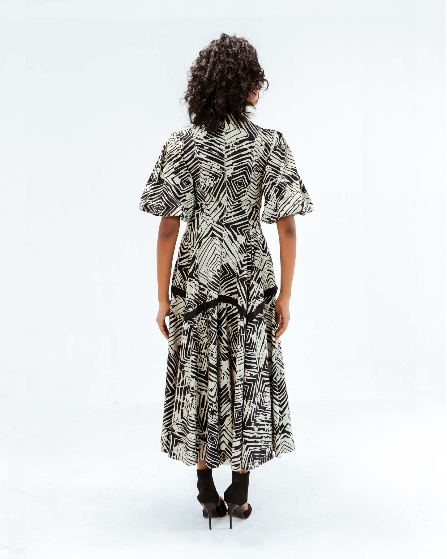 Leh Studios Florix Print Thalia Dress from the Rhythm of time collection, featuring a striking black and white geometric print. This midi-length designer wear for women showcases artisanal craftsmanship and sustainable fashion principles, offering elegant eco-friendly design.