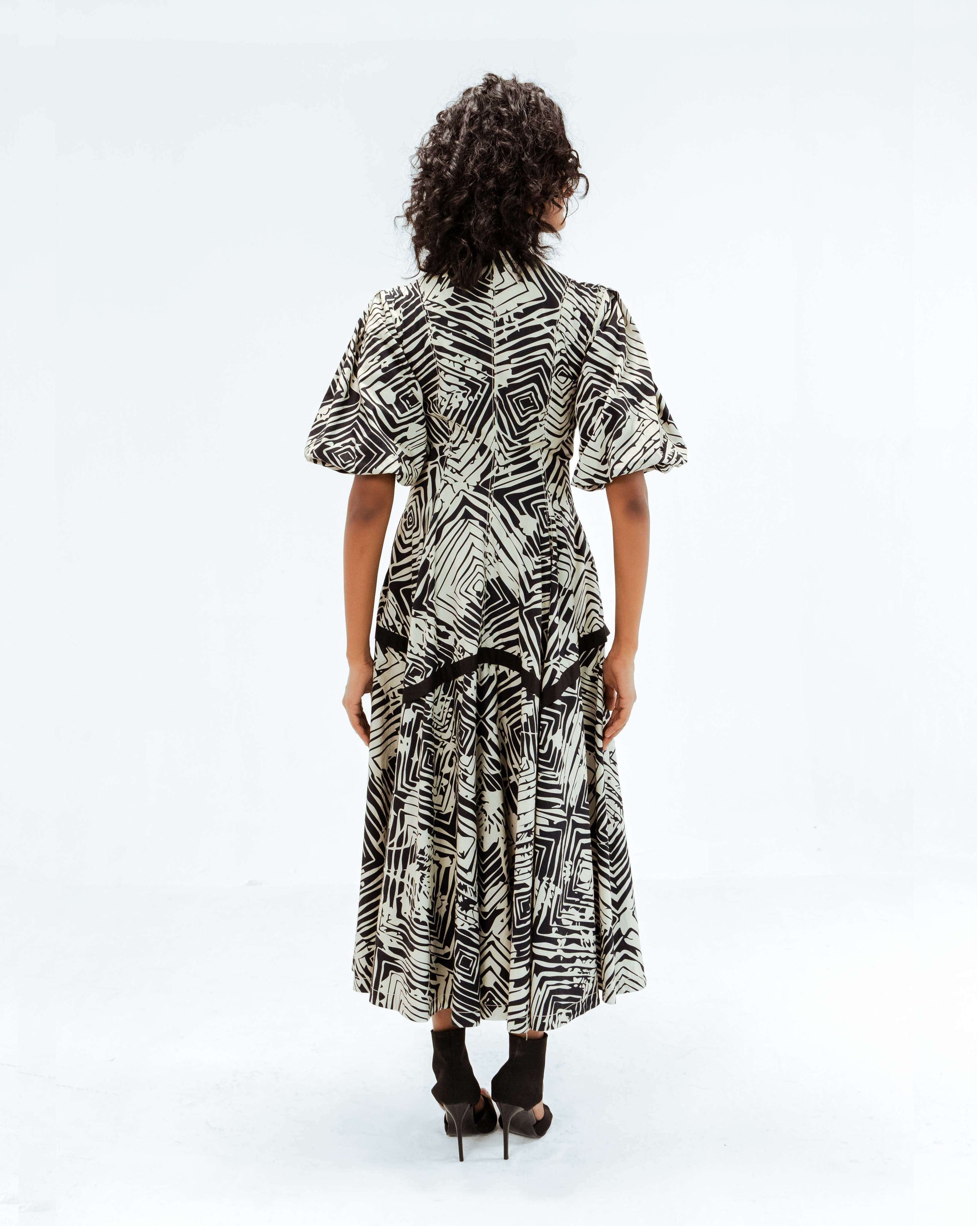 Leh Studios Florix Print Thalia Dress from the Rhythm of time collection, featuring a striking black and white geometric print. This midi-length designer wear for women showcases artisanal craftsmanship and sustainable fashion principles, offering elegant eco-friendly design.
