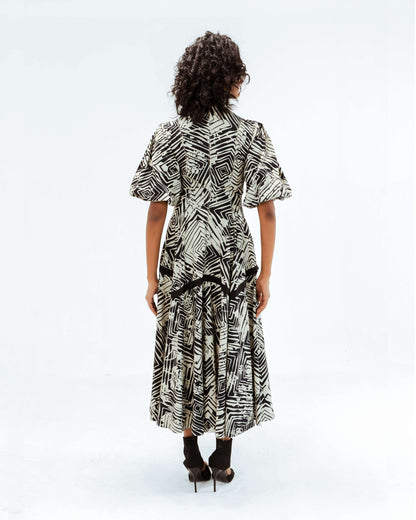 Leh Studios Florix Print Thalia Dress from the Rhythm of time collection, featuring a striking black and white geometric print. This midi-length designer wear for women showcases artisanal craftsmanship and sustainable fashion principles, offering elegant eco-friendly design.