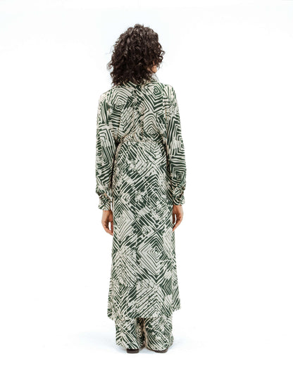Back view of the Leh Studios Florix Print Crepe Cape Dress, part of the Rhythm of Time collection. This chic womens apparel is crafted with sustainable fashion principles, featuring a vibrant green geometric Florix print on flowing crepe fabric, showcasing Leh clothing's dedication to responsible creativity and designer dresses.
