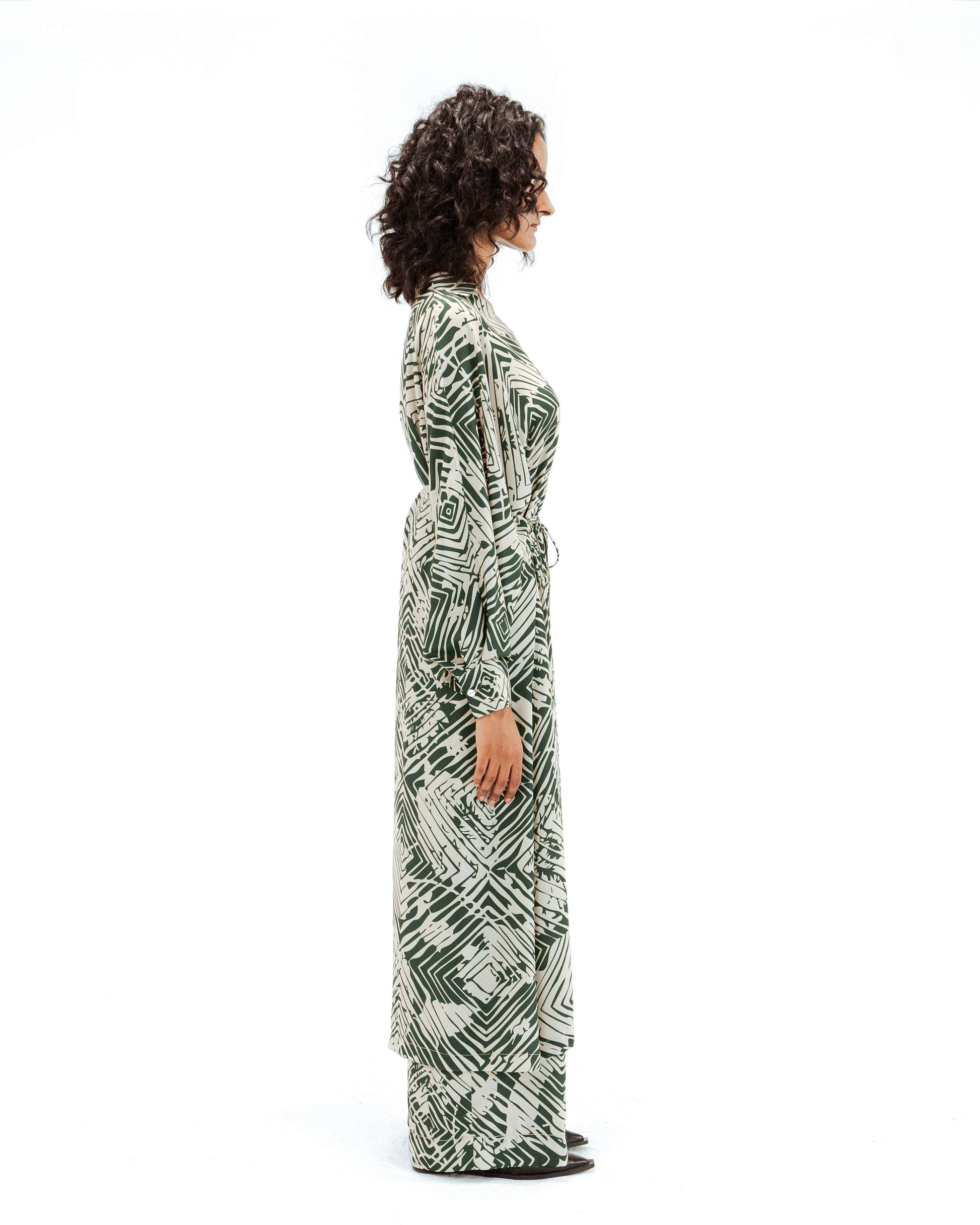 Woman wearing a patterned dress on a white background from Leh Studios.