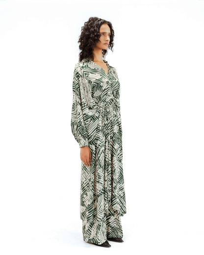 Woman wearing a long, patterned dress on a white background from Leh Studios.