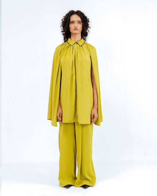 The Leh Studios Cherice Crepe Cordset, a striking mustard yellow ensemble from the Rhythm of Time collection, showcases contemporary womens apparel. This eco-friendly design features a relaxed cape-style top and comfortable wide-leg pants, representing ethical fashion and Leh clothing innovation.