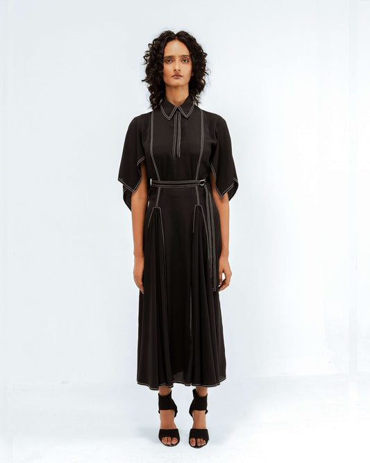 Woman wearing a black dress with a white background from Leh Studios.