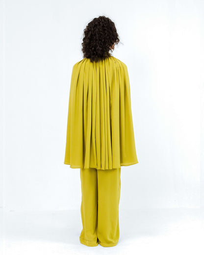 Model from behind in the vibrant chartreuse Cherice Crepe Cordset by Leh Studios, part of their Rhythm of time collection. This ethical fashion design showcases artisanal craftsmanship in a contemporary two-piece set, perfect for eco-friendly womens apparel.
