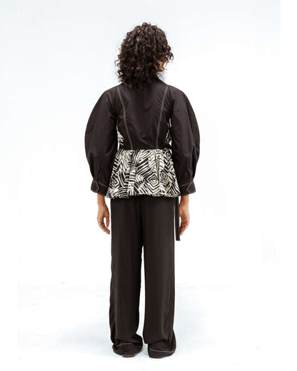 Leh Studios Fable top from the Rhythm of time collection, a black sustainable fashion piece featuring voluminous sleeves, intricate white stitching, and a pleated black and white abstract pattern. Made with organic cotton and showcasing artisanal craftsmanship, perfect for eco-conscious womens apparel.